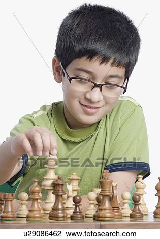 Stock Image - Close-up of a boy playing chess. Fotosearch