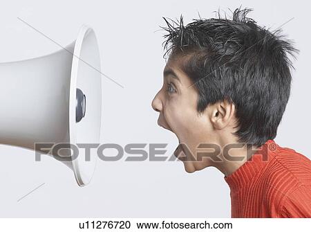Close-up of a boy shouting in front of a megaphone View Large Photo Image Stock Image - Close-up of a boy shouting in front of a megaphone. Fotosearch
