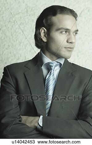 Close-up of a businessman looking away View Large Photo Image Stock Image - Close-up of a businessman looking away. Fotosearch