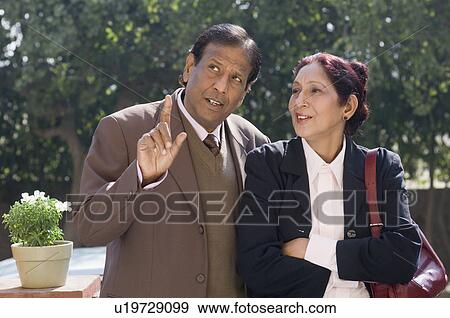 Stock Photo - Close-up of a businessman talking to a businesswoman. Fotosearch