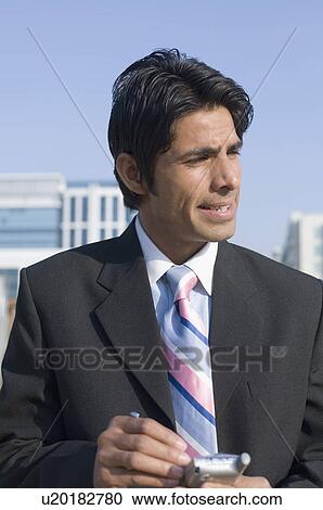 Close-up of a businessman using a personal data assistant View Large Photo Image Stock Image - Close-up of a businessman using a personal data assistant. Fotosearch