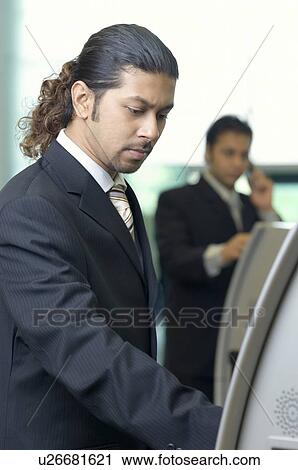 Close-up of a businessman using an automatic ticket machine View Large Photo Image Stock Image - Close-up of a businessman using an automatic ticket machine. Fotosearch