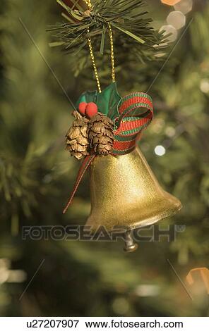 Close-up of a Christmas bell hanging on a Christmas tree View Large Photo Image Stock Photo - Close-up of a Christmas bell hanging on a Christmas tree. Fotosearch