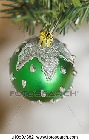 Stock Image - Close-up of a Christmas ornament hanging on a Christmas tree. Fotosearch