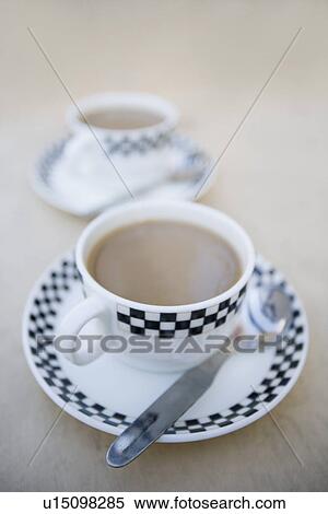 Stock Photography - Close-up of a cup of tea with a spoon on a saucer. Fotosearch