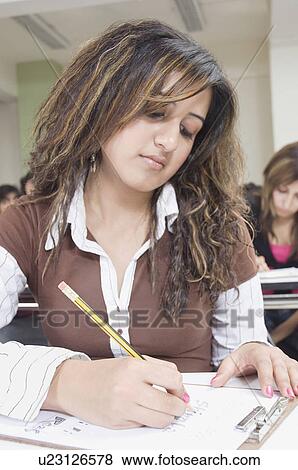Close-up of a female college student giving an exam View Large Photo Image Stock Photo - Close-up of a female college student giving an exam. Fotosearch