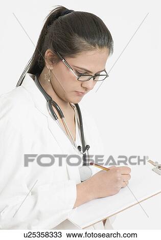 Close-up of a female doctor writing on a clipboard View Large Photo Image Stock Image - Close-up of a female doctor writing on a clipboard. Fotosearch