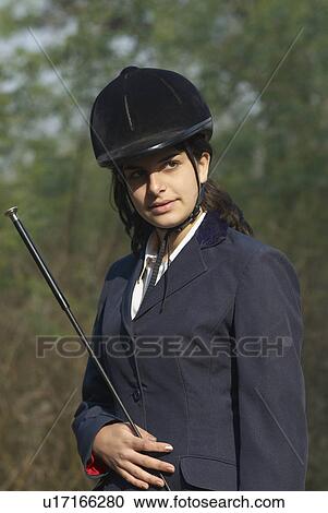 Close-up of a female jockey holding a riding crop View Large Photo Image Stock Image - Close-up of a female jockey holding a riding crop. Fotosearch
