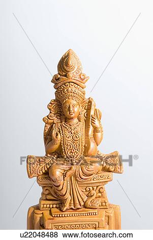 Close-up of a figurine of Goddess Saraswati View Large Photo Image Stock Photo - Close-up of a figurine of Goddess Saraswati. Fotosearch