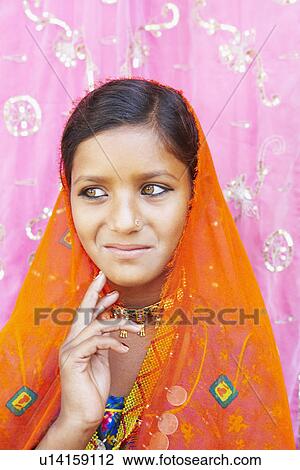 Stock Image - Close-up of a girl in a traditional clothing and looking away. Fotosearch