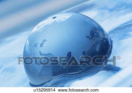 Picture - Close-up of a globe on the surface of water. Fotosearch