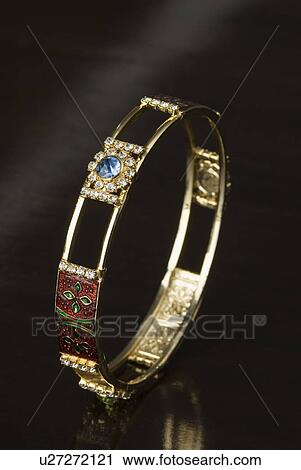 Close-up of a gold bracelet View Large Photo Image Stock Image - Close-up of a gold bracelet. Fotosearch