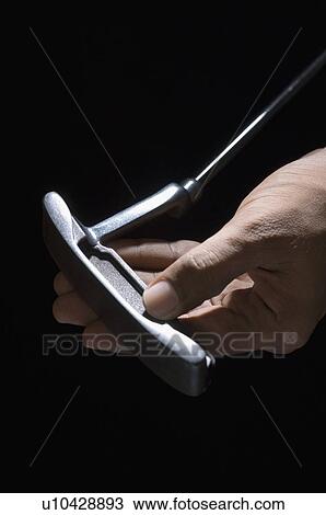 Stock Image - Close-up of a man's hand holding a golf club. Fotosearch