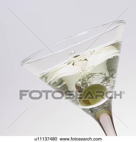 Close-up of a martini with a green olive in it View Large Photo Image Stock Image - Close-up of a martini with a green olive in it. Fotosearch