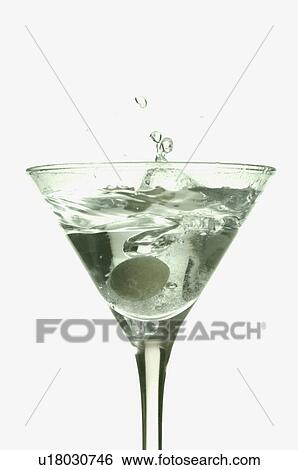 Stock Photograph - Close-up of a martini with a green olive in it. Fotosearch
