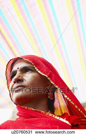 Stock Image - Close-up of a mature woman in a traditional clothing. Fotosearch
