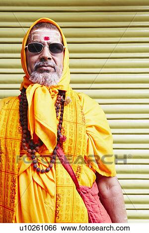 Stock Photograph - Close-up of a sadhu wearing sunglasses. Fotosearch