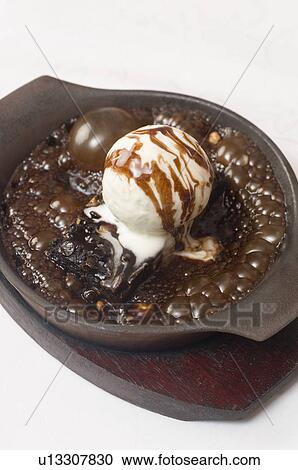 Stock Image - Close-up of a sizzling brownie with ice cream. Fotosearch