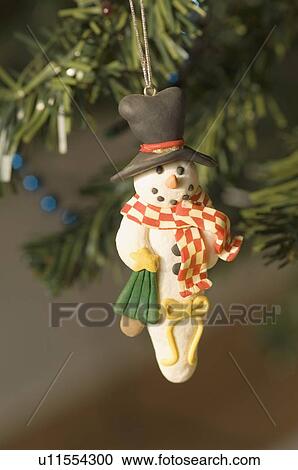 Close-up of a snowman hanging on a Christmas tree View Large Photo Image Stock Image - Close-up of a snowman hanging on a Christmas tree. Fotosearch