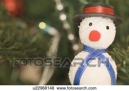 Close-up of a snowman hanging on a Christmas tree View Large Photo Image Stock Photo - Close-up of a snowman hanging on a Christmas tree. Fotosearch
