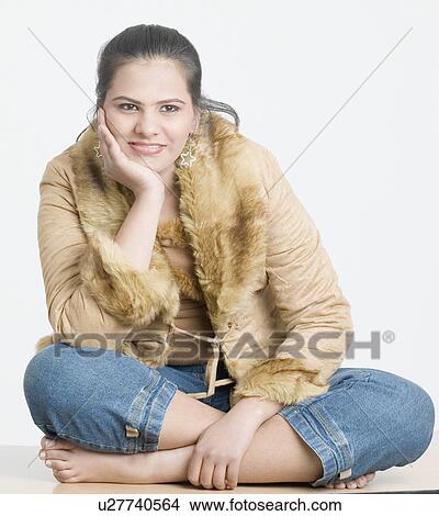 Close-up of a teenage girl smiling with her hand on her chin View Large Photo Image Picture - Close-up of a teenage girl smiling with her hand on her chin. Fotosearch