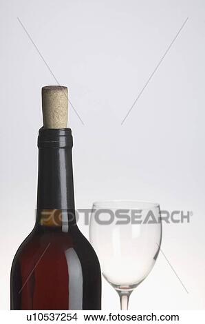Picture - Close-up of a wine bottle and a wine glass. Fotosearch