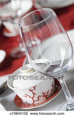 Stock Image - Close-up of a wine glass with a bowl on a saucer. Fotosearch