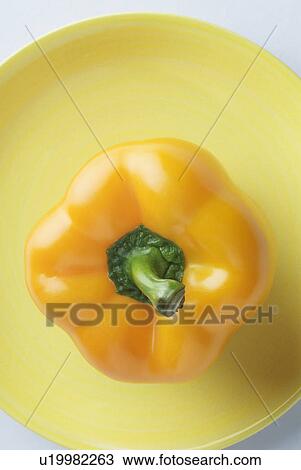 Close-up of a yellow bell pepper on a plate View Large Photo Image Stock Image - Close-up of a yellow bell pepper on a plate. Fotosearch