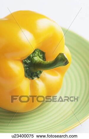 Stock Photography - Close-up of a yellow bell pepper on a plate. Fotosearch