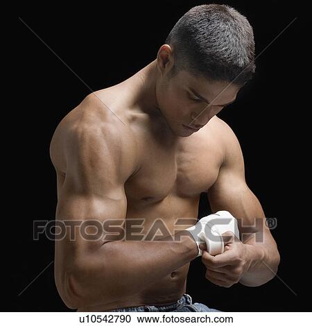 Close-up of a young man bandaging his hand View Large Photo Image Stock Image - Close-up of a young man bandaging his hand. Fotosearch