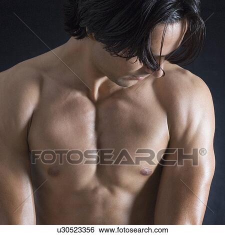 Close-up of a young man flexing his muscles View Large Photo Image Stock Photograph - Close-up of a young man flexing his muscles. Fotosearch
