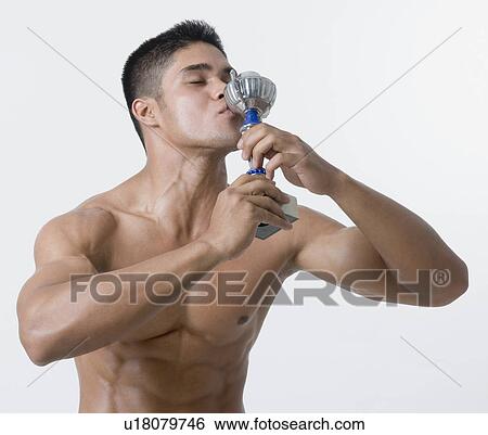 Close-up of a young man kissing a trophy View Large Photo Image Stock Photograph - Close-up of a young man kissing a trophy. Fotosearch