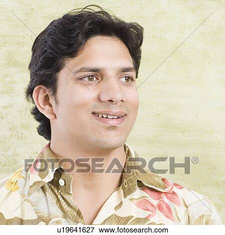 Stock Photo - Close-up of a young man looking away. Fotosearch