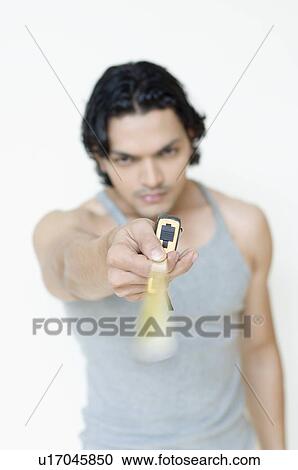 Stock Image - Close-up of a young man showing a tape measure. Fotosearch