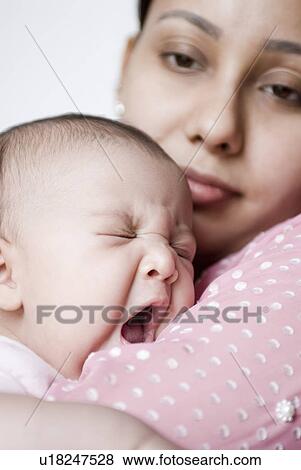 Stock Photo - Close-up of a young woman holding her daughter. Fotosearch