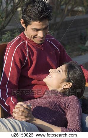 Close-up of a young woman lying on the lap of a young man View Large Photo Image Stock Image - Close-up of a young woman lying on the lap of a young man. Fotosearch