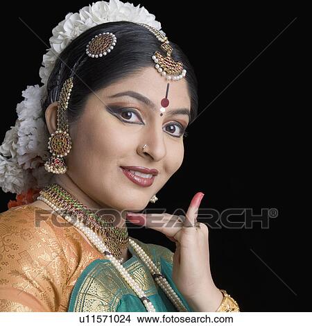 Picture - Close-up of a young woman performing Bharatnatyam. Fotosearch