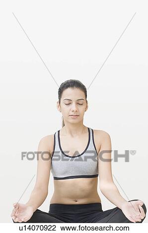 Close-up of a young woman performing yoga View Large Photo Image Stock Image - Close-up of a young woman performing yoga. Fotosearch