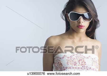 Stock Photograph - Close-up of a young woman wearing eyeglasses. Fotosearch