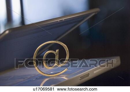 Stock Image - Close-up of an At Symbol on a laptop. Fotosearch