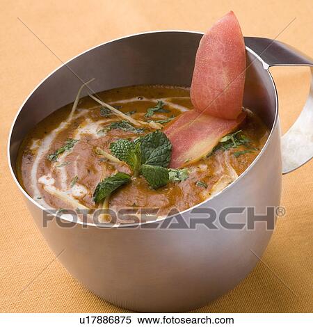 Stock Photography - Close-up of black lentil curry in a mug. Fotosearch