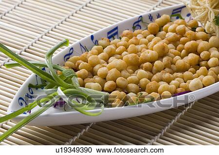 Stock Image - Close-up of boiled chick-peas on a platter. Fotosearch