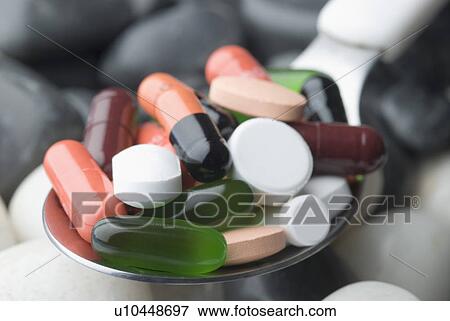 Close-up of capsules and tablets in a spoon View Large Photo Image Stock Photo - Close-up of capsules and tablets in a spoon. Fotosearch