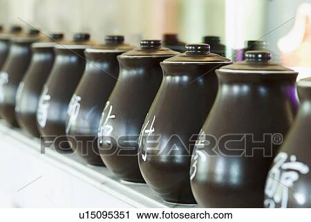 Stock Image - Close-up of ceramic jars in a row. Fotosearch
