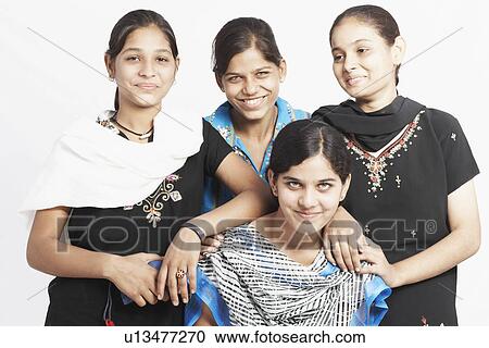 Stock Image - Close-up of four girls smiling together. Fotosearch
