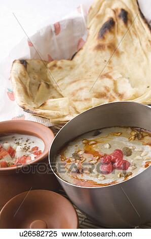 Stock Photography - Close-up of Indian breads served with curry and curd. Fotosearch