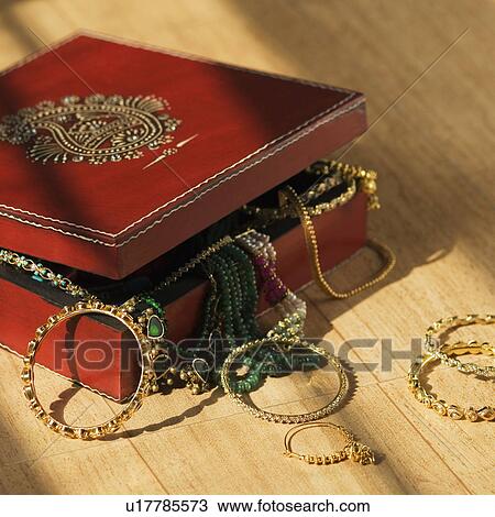 Stock Image - Close-up of jewelry spilling from a box. Fotosearch