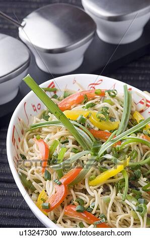 Stock Image - Close-up of mixed fried noodles on a platter. Fotosearch