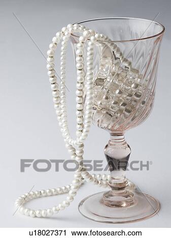 Close-up of pearl necklaces in a wine glass View Large Photo Image Stock Image - Close-up of pearl necklaces in a wine glass. Fotosearch