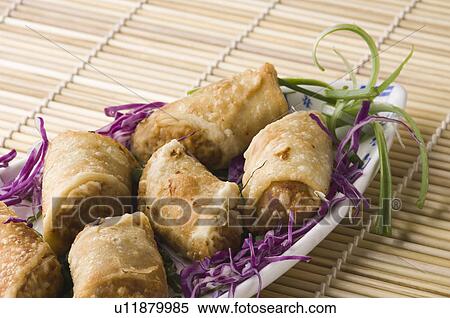 Close-up of spring rolls in a tray View Large Photo Image Stock Photography - Close-up of spring rolls in a tray. Fotosearch
